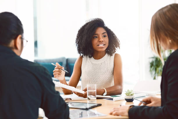 Shot of a group of young businesspeople having a meeting in a modern office